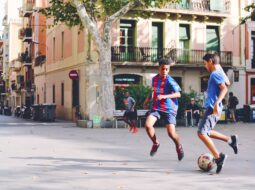 Community members playing soccer together, reflecting the global influence of soccer across cultures.