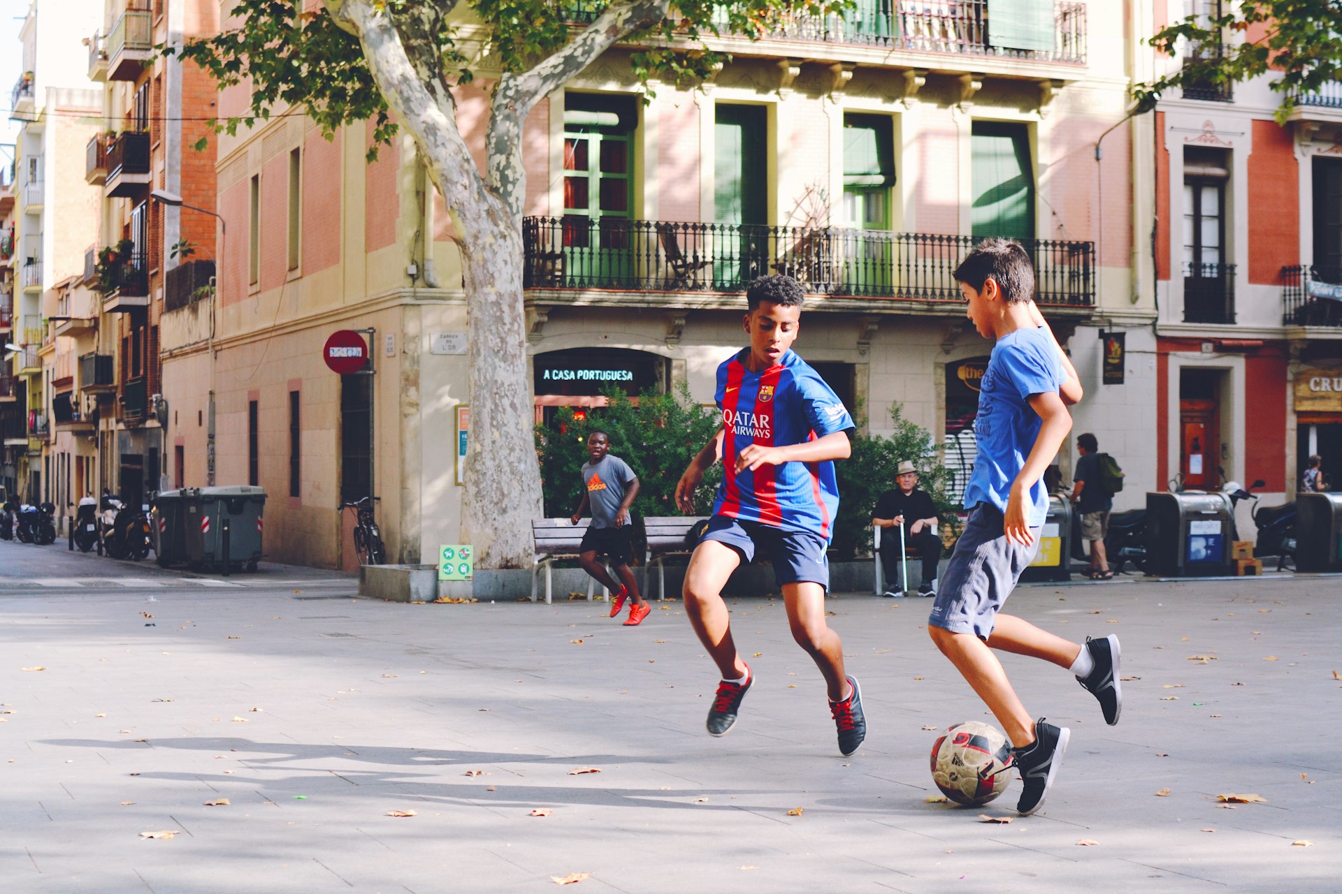 Community members playing soccer together, reflecting the global influence of soccer across cultures.